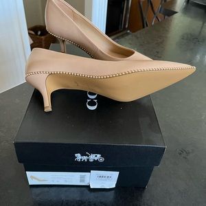 Coach pumps with a kitten heel.  Never worn.
